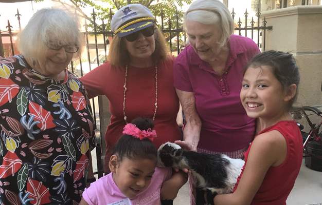 silverado residents and children with a goat