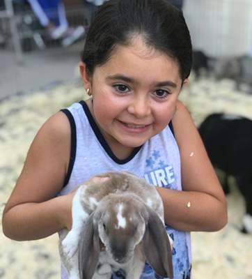 young girl holding a rabbit